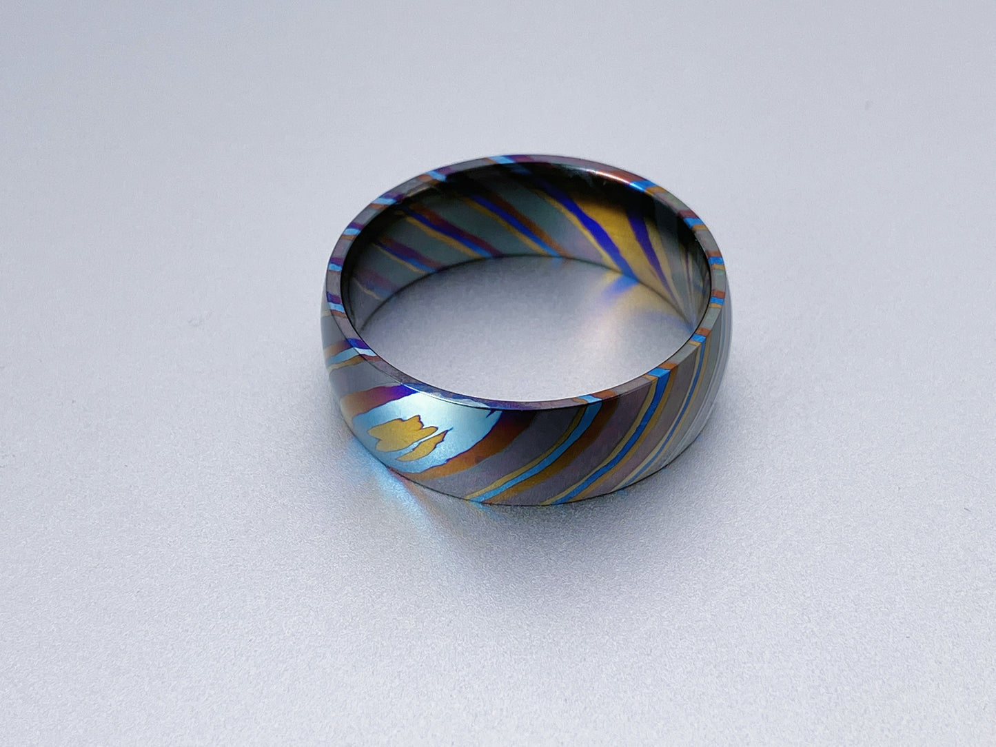 Mokume ZircTi (ZircTi Damascus) ring, four alloys twisted pattern, dome and polish pattern, 8mm wide